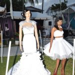 Classic Styles’ models displaying two of their wedding gowns before owning the stage at the fashion segment.