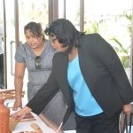 Prime Ministerial Candidate Elisabeth Harper examines forestry products at the exhibition to commemorate International Day of Forests and the Tree yesterday 