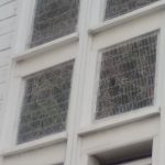 The damaged mesh on the outside of the stained glass windows.  