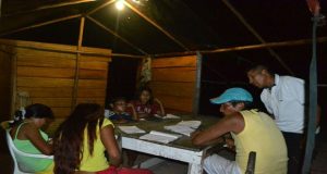 Children of Arau in Region Seven doing homework at night. This was made possible through the provision of solar panels by the Government 