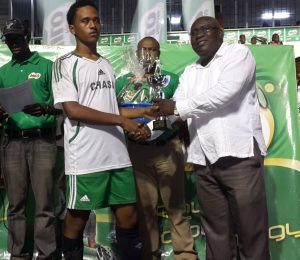  This year’s tournament Most Valuable Player Isaiah Reddy of Chase Academy accepts his accolades from this Ministry of Education official. 