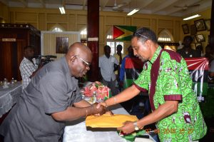 GECOM’s Chief Elections Officer Keith Lowenfield receives documentation from Leader of the Organisation For the Victory of the People Party Gerald Pereira 