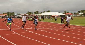 Rupert Perry (#136) storms to victory in the men’s 100-metre race at the National Track and Field Centre at Leonora yesterday.