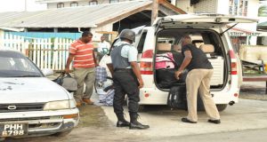Salvaging under police guard whatever household items remained 