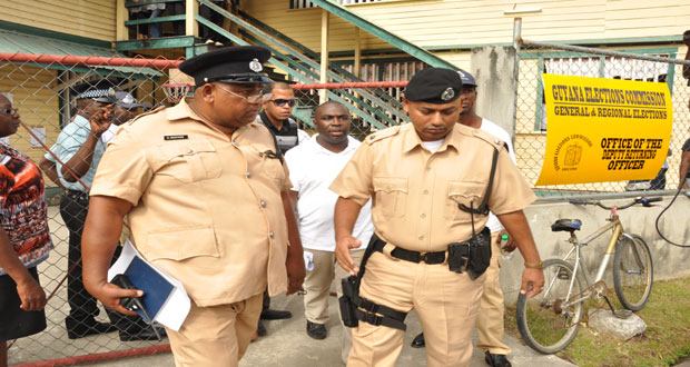 Kwame Mc Coy as he is escorted out of the St Sidwell’s Primary School, away from the angry crowd