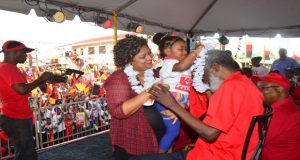 PPP stalwart, Dr. Roger Luncheon, is garlanded by one of the youngest at yesterday’s rally 