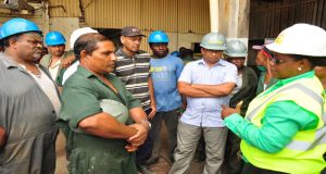 Workers listen attentively as Minister Broomes assures them there will be no closure of the sugar industry