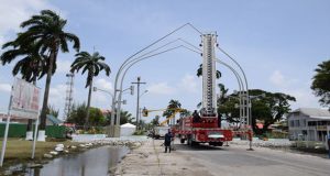 Workers using the Guyana Fire Service Truck to apply finishing touches to the Independence Arch