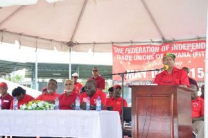 GAWU’s Head, Komal Chand at the podium, with Minister Clement Rohee, PPP/C's Prime Ministerial Candidate Elisabeth Harper, Prime Minister Samuel Hinds, President Donald Ramotar and FITUG Head , Carvil Duncan at the head table at the May Day 2015 rally at the National Park  