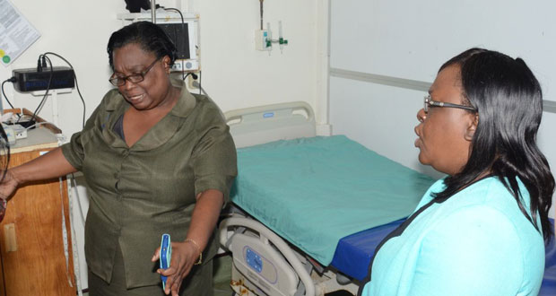 Minister Cummings, right, and Nurse Cato in discussion yesterday.