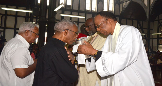 President Granger in Holy Communion at Bishop Moss’ Memorial Service. Awaiting his turn at left is Agriculture Minister Noel Holder [Photo by Adrian Narine)