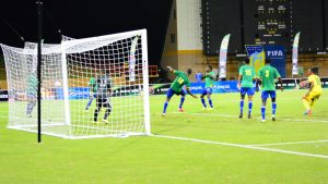Neil Danns equalises against St. Vincent and the Grenadines as the defenders watch and goalkeeper watch on helplessly. (Samuel Maughn photo)