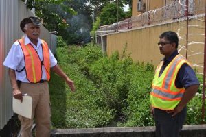 Ministry of Public Infrastructure’s Technical Advisor, Walter Willis and Gaico Construction Inc., Managing Director, Komal Singh at one of the canals between Camp and Thomas Streets