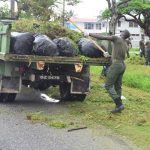 A rank dumping waste onto a tractor for disposal