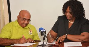 Signing the contract are, from left, Linden Technical Institute Principal, Mr. Denis Jaikarran, and Guyana Goldfields Country Manager and Senior Vice-President, Ms. Violet Smith 