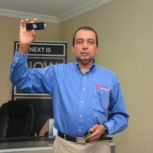 President of the Board of Directors of Starr Computers, Mr Michael Mohan showing members of the media one of the computers 