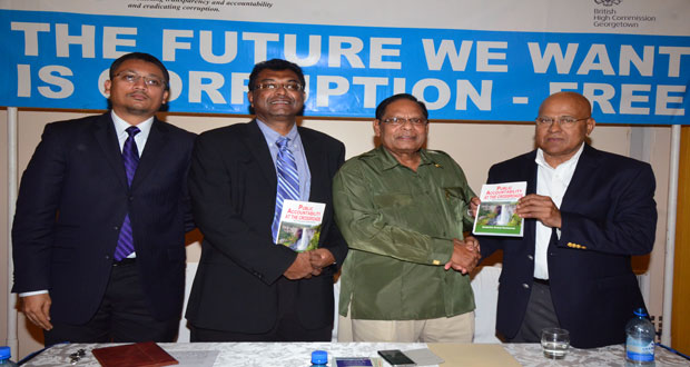 Author of ‘Public Accountability at the Crossroads’, Dr Anand Goolsarran presents a copy of his book to Prime Minister and Acting President at the time, Mr Moses Nagamootoo. Also in photo is Vice President and Minister of Public Security Mr Khemraj Ramjattan [second left) and Mr Gino Persaud of the Transparency Institute (left)