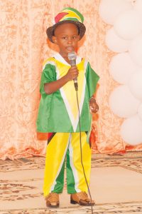 Little Daquan Davilar, appropriately dressed in the National Flag, recites the poem ‘Little Guyanese’ 