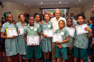 Education Minister, Dr Rupert Roopnaraine posing with St. Margaret’s Primary top performers – all of whom are Queen’s College bound 