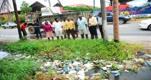 The mayor and other Heads-of-Department inspecting a clogged drain on Mandela Avenue yesterday (Photos by Delano Williams)