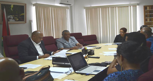 Minister Raphael Trotman, seated at left, and others at the meeting
