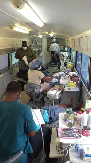 Staffers tending to children inside the dental mobile unit on Friday