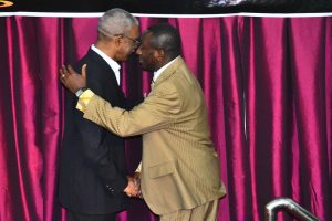 Pastor Joel Uwagboe of Freedom Life Ministries hugs President Granger upon his arrival yesterday at the church’s anniversary celebrations 
