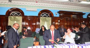 Opposition Leader Bharrat Jagdeo is applauded by his fellow MP’s as he takes his seat in the National Assembly