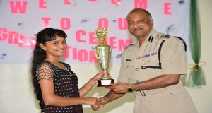 Top performer Shaneeza Khan as she was presented a trophy by ‘Top Cop’ Seelall Persaud