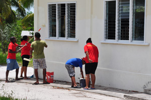 Staff of Roraima Airways braving the scorching sun as they refurbish the Santa Mission Primary School 