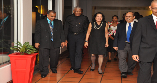 President David Granger and First Lady Sandra Granger being escorted into the Savannah Suite at the Pegasus Hotel by Chairman of the Board of Directors of Food For The Poor [Guyana), Paul Chan-A-Sue (right) and Chief Executive Officer Kent Vincent (left). The event was the annual fundraising dinner hosted by the leading charitable organization last Friday evening. (Delano Williams photo)