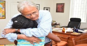 Education Minister, Dr. Rupert Roopnaraine is impressed by eight-year-old author Anaya  