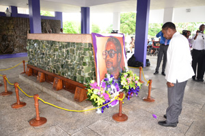 Immediate past leader of the PNC, Robert Corbin, pays his respects to L.F.S. Burnham, on August 6, 2015