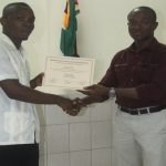 Best Graduating Student, Marlon Hannibal  receiving his certificate from Superintendent Wayne De Hearte  