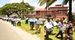 Rice farmers picketing outside Ministry of the Presidency, yesterday