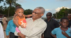 President Granger holds a young girl who was eager to meet “President Granger”
