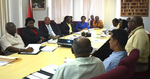 Minister Raphael Trotman pays rapt attention as acting Commissioner GGMC, Newell Dennison presents the draft plan