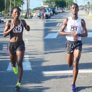 In this Samuel Maughn composite photo, Cleveland Forde (right) stops his clock as he crosses the finish line, while at left, Alika Morgan approaches the finish line. Both athletes won their respective categories unchallenged.