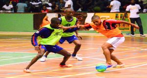 Bent Street’s Stellon David (right) takes on two Sparta defenders in the final of the GT Beer Futsal competition, on Sunday night at the Cliff Anderson Sports Hall.