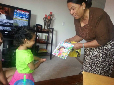 Veeren gives a present to one of her grandchildren.