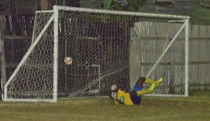 Beaten! Fruta Conquerors goalkeeper Alex Murray beaten by Slingerz FC’s Tichard Joseph (not in picture) from the penalty spot 