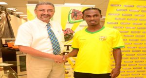 Gregory ‘Jackie Chan’ Richardson shakes the hand of COURTS Country Manager Clyde de Haas. (Adrian Narine photos)