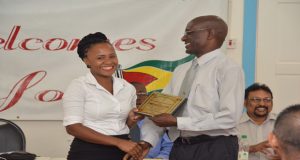 Valedictorian Jenella Paul receives an award from Orthopaedic Consultant Dr. Fawcett Jeffrey  