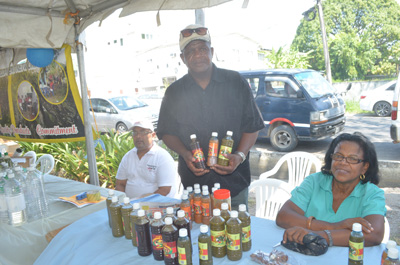 A representative proudly displays the products of Alpha Manufacturing Inc., a company run by five women. (Cullen Bess-Nelson)