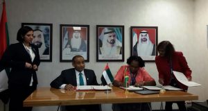 Minister within the Ministry of Public Infrastructure Anette Ferguson, signing the agreement with a UAE official 