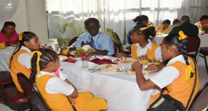 The students of Baramita Primary having breakfast with PAHO/WHO Guyana Representation, Dr. William Adu-Krow. 