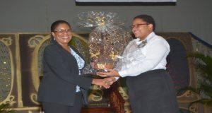 Tourism Minister Cathy Hughes receives a special gift from Carnegie Vice-Principal Myrna Audry Lee