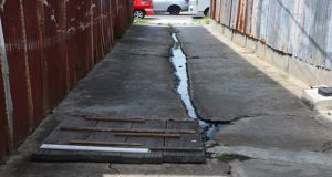 The sewage overflow that causes a horrible sight and stench  in the passageway. 