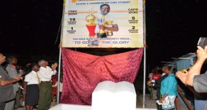 President David Granger and 2014 CSEC top regional performer Elisa Hamilton, who is also a 2015 top performer at CAPE, unveiling a billboard in honour of her achievements at the Ann's Grove Market tarmac, on Sunday evening