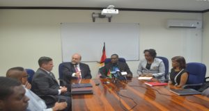 U.S. Ambassador Perry Holloway explaining aspects of the MoU to the media in the presence of Public Infrastructure Ministers David Patterson and Annette Ferguson, and officials of the GCAA and the U.S. Embassy